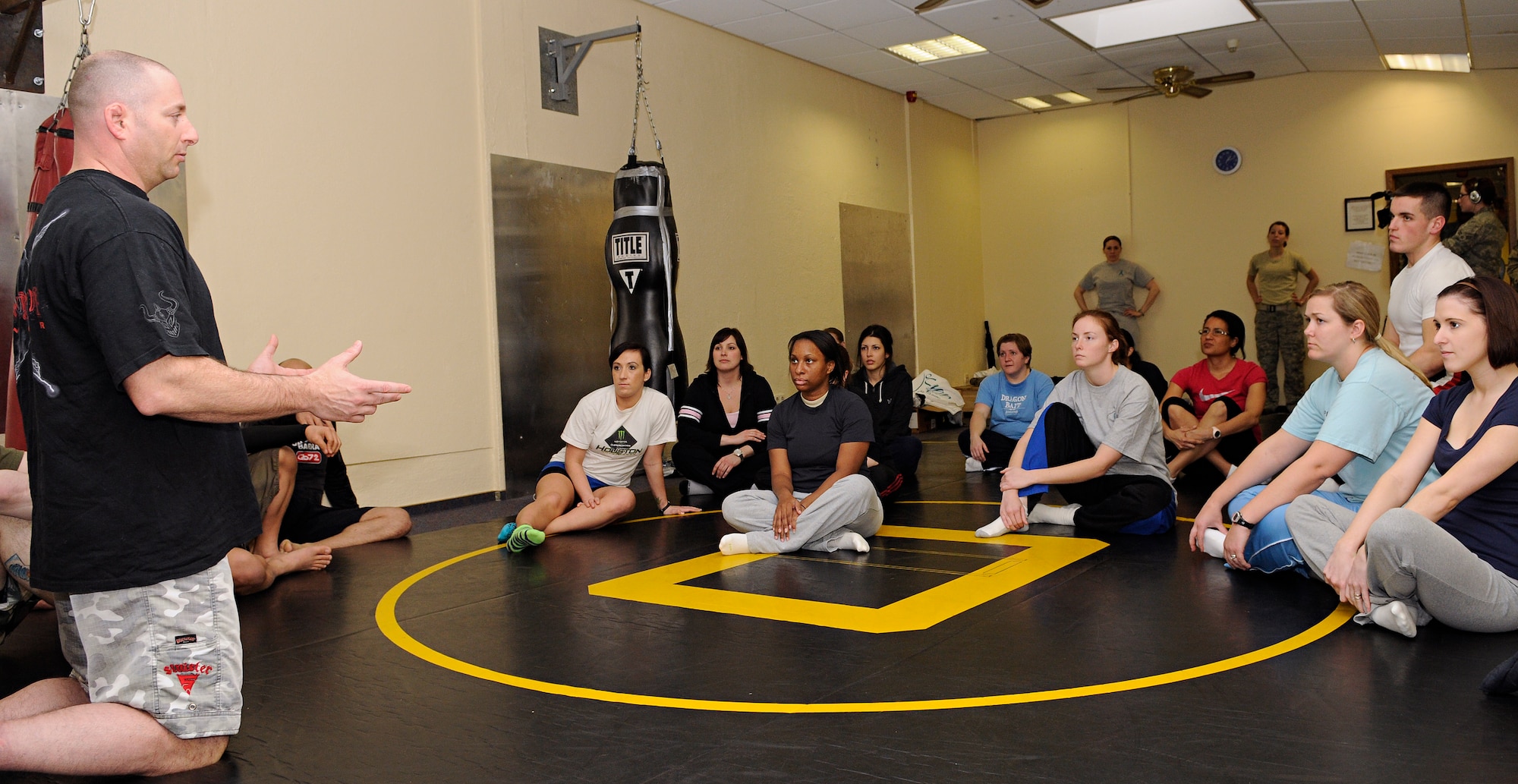 SPANGDAHLEM AIR BASE, Germany – Master Sgt. John Cammarata, 52nd Civil Engineer Squadron member and mixed martial arts coach, speaks to a group of women before beginning a self-defense class at Skelton Memorial Fitness Center March 26. The class was one of many events conducted during Sexual Assault Awareness Month to make people more aware of sexual assault prevention and response programs. (U.S. Air Force photo/Senior Airman Benjamin Wilson)