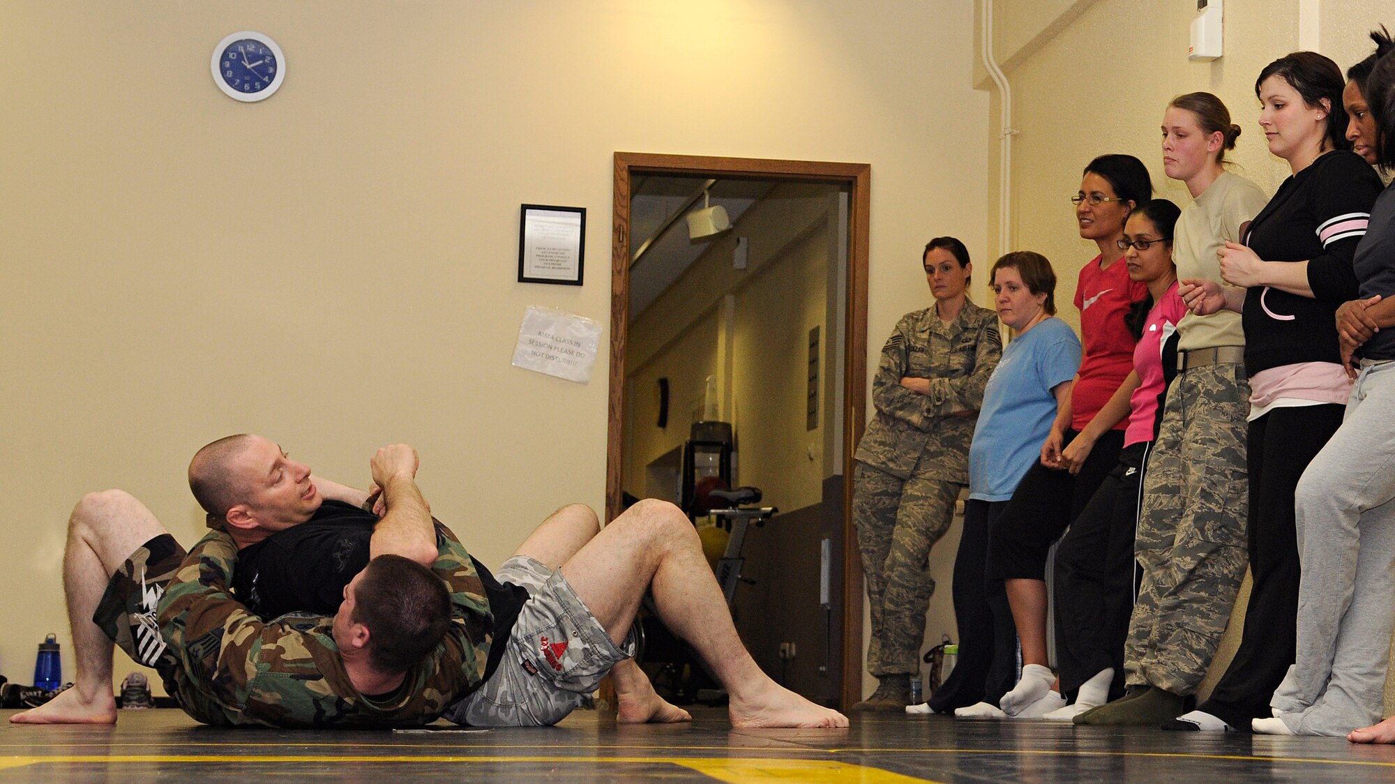 SPANGDAHLEM AIR BASE, Germany – Master Sgt. John Cammarata, 52nd Civil Engineer Squadron member and mixed martial arts coach, demonstrates how to escape someone’s grasp using elbow strikes on Staff Sgt. Danny Hawkins, 52nd Aircraft Maintenance Squadron, during a self-defense class at Skelton Memorial Fitness Center March 26. Approximately 15 women attended the class, which was one of many events held during Sexual Assault Awareness Month. (U.S. Air Force photo/Senior Airman Benjamin Wilson)