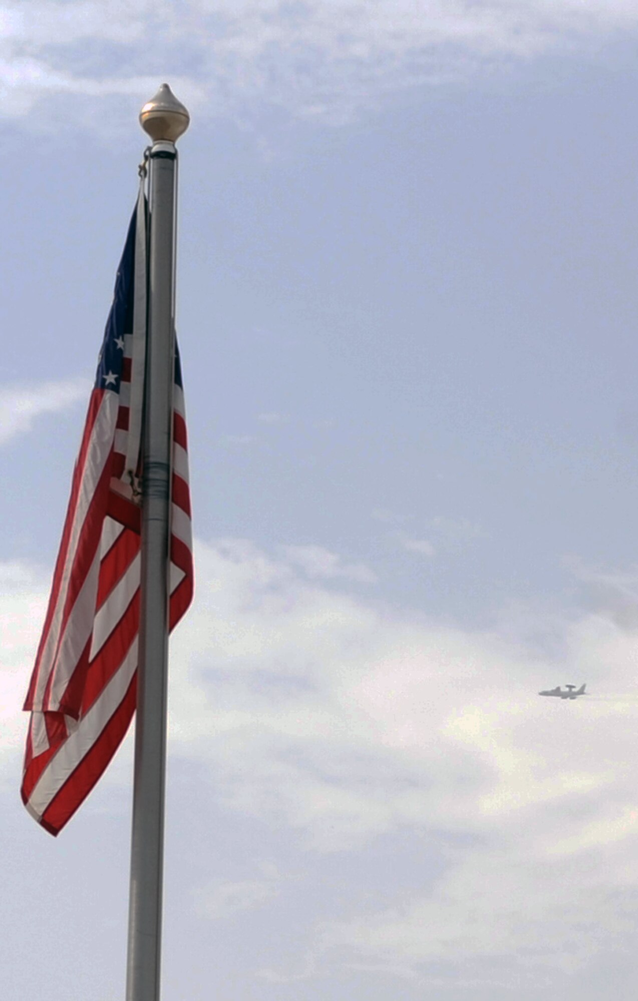 An E-3 Sentry Airborne Warning and Control System aircraft from the 965th Expeditionary Airborne Air Control Squadron takes off for a combat air mission within  view of the American flag in front of 380th Air Expeditionary Wing Headquarters at a non-disclosed base in Southwest Asia on March 31, 2010. The 965th EAACS, as part of the 380th AEW, supports operations Iraqi Freedom and Enduring Freedom and the Combined Joint Task Force-Horn of Africa. (U.S. Air Force Photo/Master Sgt. Scott T. Sturkol/Released)