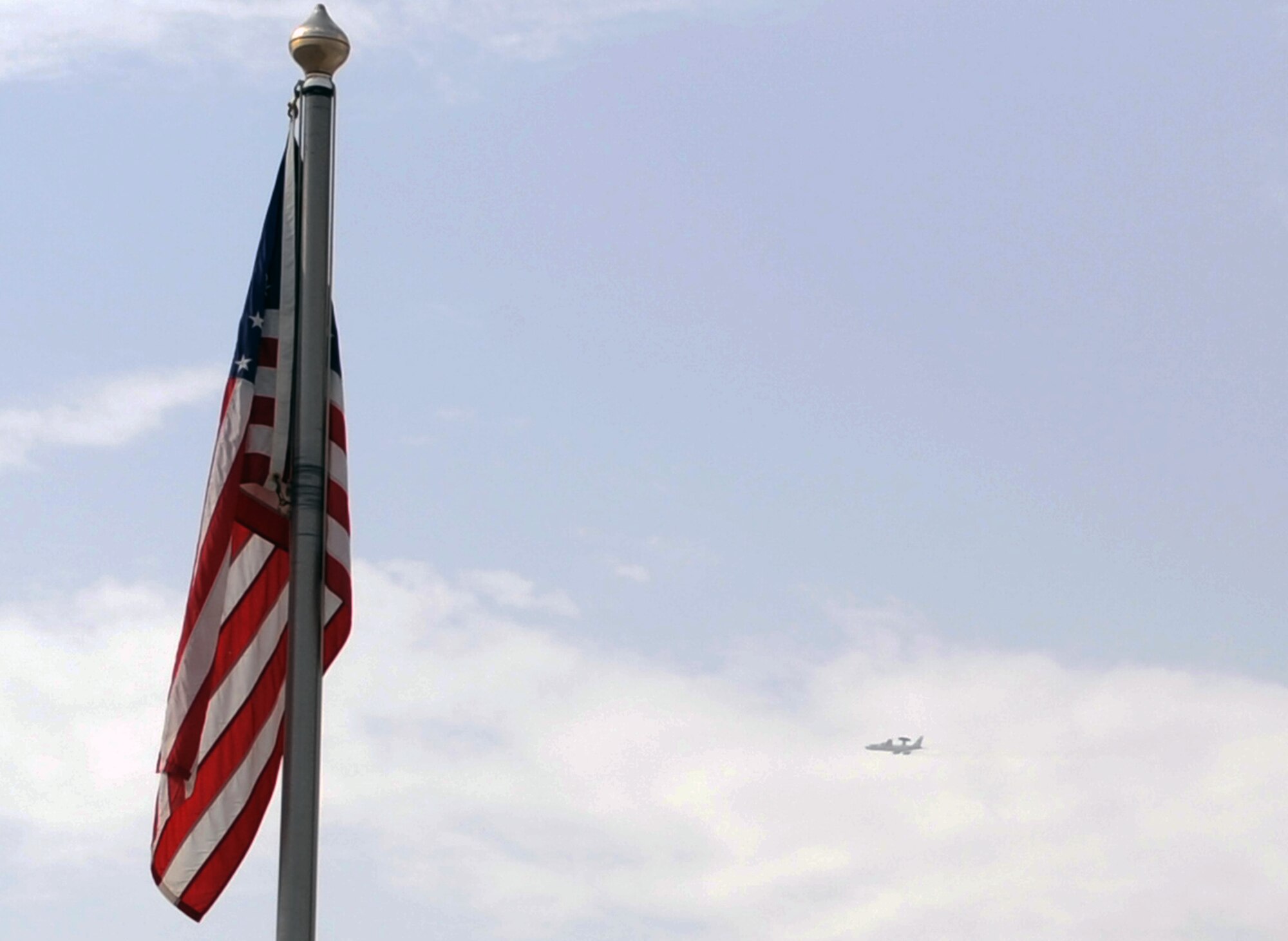 An E-3 Sentry Airborne Warning and Control System aircraft from the 965th Expeditionary Airborne Air Control Squadron takes off for a combat air mission within  view of the American flag in front of 380th Air Expeditionary Wing Headquarters at a non-disclosed base in Southwest Asia on March 31, 2010. The 965th EAACS, as part of the 380th AEW, supports operations Iraqi Freedom and Enduring Freedom and the Combined Joint Task Force-Horn of Africa. (U.S. Air Force Photo/Master Sgt. Scott T. Sturkol/Released)