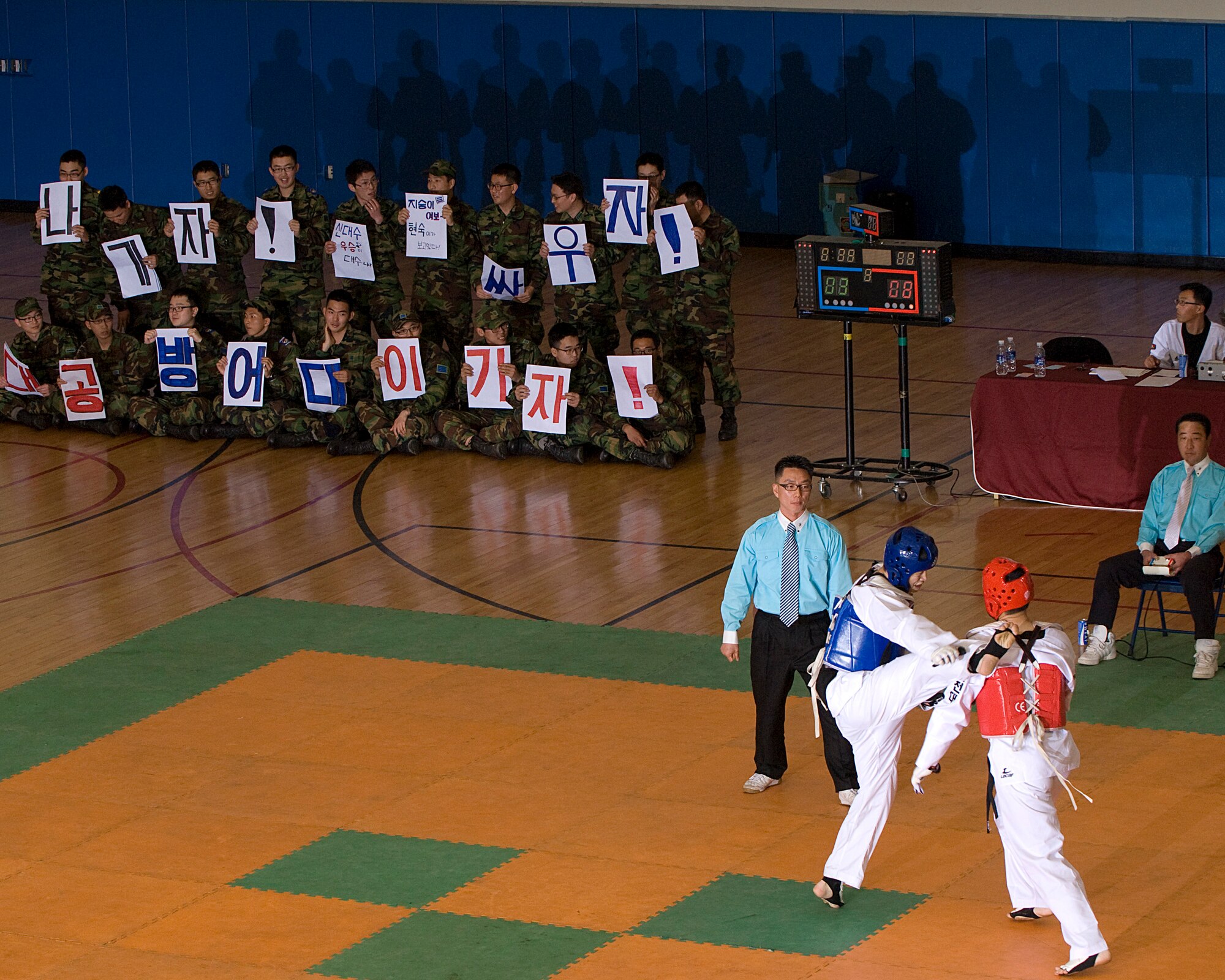 KUNSAN AIR BASE, Republic of Korea -- A crowd of fans cheer on competitors during the 7th Republic of Korea Air Force and U.S. Air Force Taekwondo Tournament March 23. The tournament allowed members from the 8th Fighter Wing and the 38th Fighter Group to strength their relationship and learn a little of each other's culture. (U.S. Air Force photo/Senior Airman Roy Lynch)