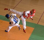 KUNSAN AIR BASE, Republic of Korea -- Tech. Sgt Cody Morris, 8th Maintenance Squadron, ducks while Airman 1st Class Sin Dae Soo, 38th Fighter Group, kicks during the 7th Republic of Korea Air Force and U.S. Air Force Taekwondo Tournament March 23. Sparing consisted of three rounds of head to head sparing where points are earned from kicks that make contact. (U.S. Air Force photo/Senior Airman Roy Lynch)