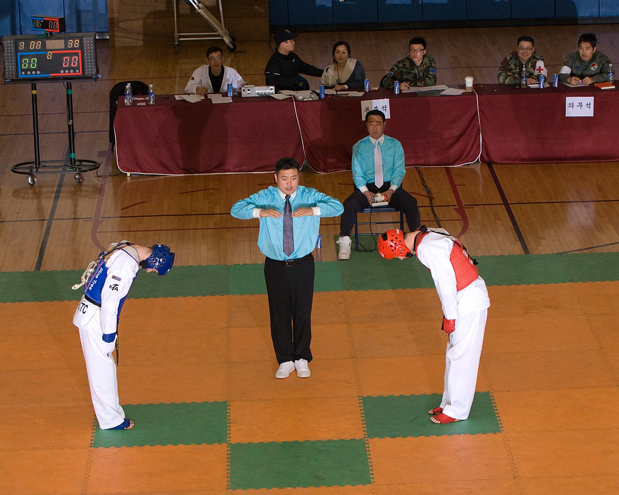 KUNSAN AIR BASE, Republic of Korea -- Participants and judges prepare for the beginning of a match during the 7th Republic of Korea Air Force and U.S. Air Fore Taekwondo Tournament March 23. The tournament consisted of 65 participants in three different events. (U.S. Air Force photo/Senior Airman Roy Lynch)