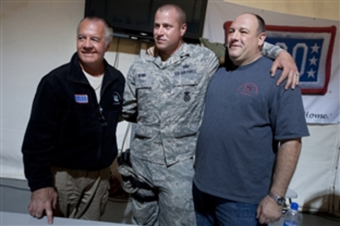 Tony Sirico, left, and James Gandolfini from HBO's "The Sopranos" pose for photos with a servicemember stationed in Kuwait, March 31, 2010. Sirico, Gandolfini, New Orleans Saint Jon Stinchcomb and actress Rose McGowen accompanied U.S. Navy Adm. Mike Mullen, chairman of the Joint Chiefs of Staff, on a USO tour in the region. 