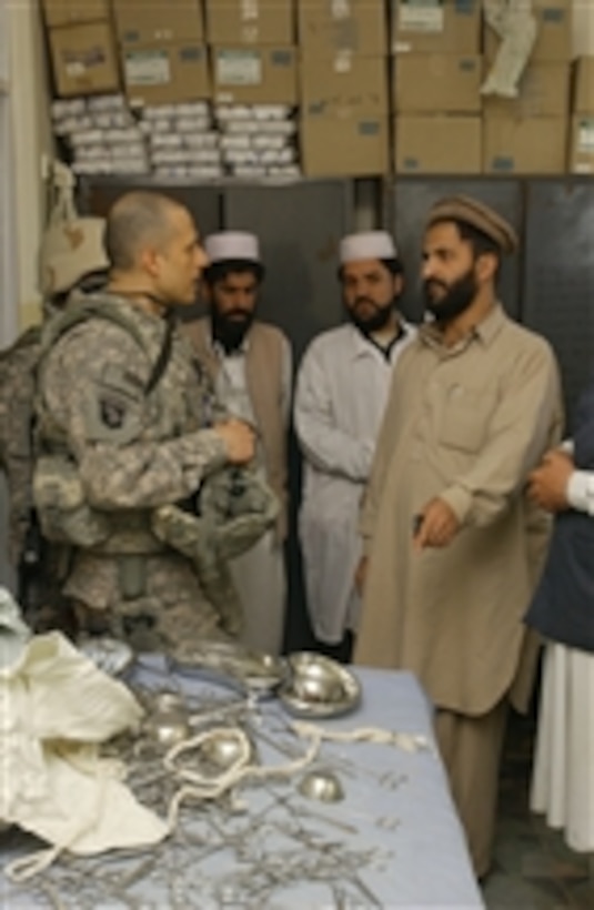 U.S. Navy Lt. j.g. Vince Lopez, a medical officer with the Paktika Provincial Reconstruction Team, speaks with Ahmad Baseer, public health advisor for Paktika province, about the quantity and quality of his hospital's medical supplies, at the Sharana hospital in Paktika province, Afghanistan, on March 22, 1010.  Lopez toured the hospital to view completed projects, schedule staff training for new equipment and receive an update on future hospital plans.  