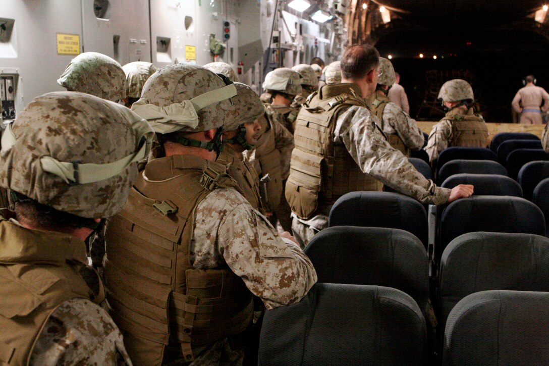Marines with 3rd Marine Aircraft Wing (Forward) wait in combat gear to file off a military transport aircraft to begin their one-year deployment aboard Camp Leatherneck, Helmand province, Islamic Republic of Afghanistan in support of Operation Enduring Freedom. A transfer of authority is scheduled for April.
