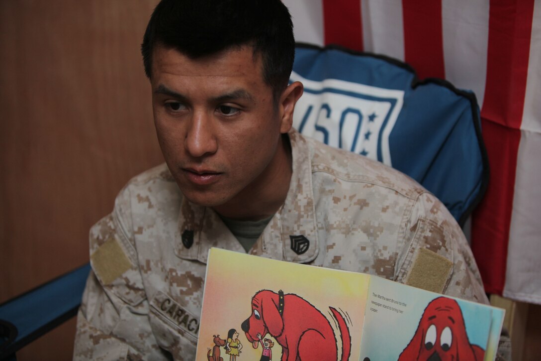 Staff Sgt. Juan Carachure, supply administrative clerk with Combat Logistics Company 252, Marine Expeditionary Brigade-Afghanistan, 30, from Fresno, Calif., reads aloud in front of a video camera so he can send it to his 5-year-old daughter back home during a session of the United Through Reading program on Camp Leatherneck, Afghanistan, March 31. The United Through Reading program helps service members stay connected with their loved ones who are supporting them back at home by allowing troops to record and read aloud books to their children, and then mail the recordings as DVD's to their families.