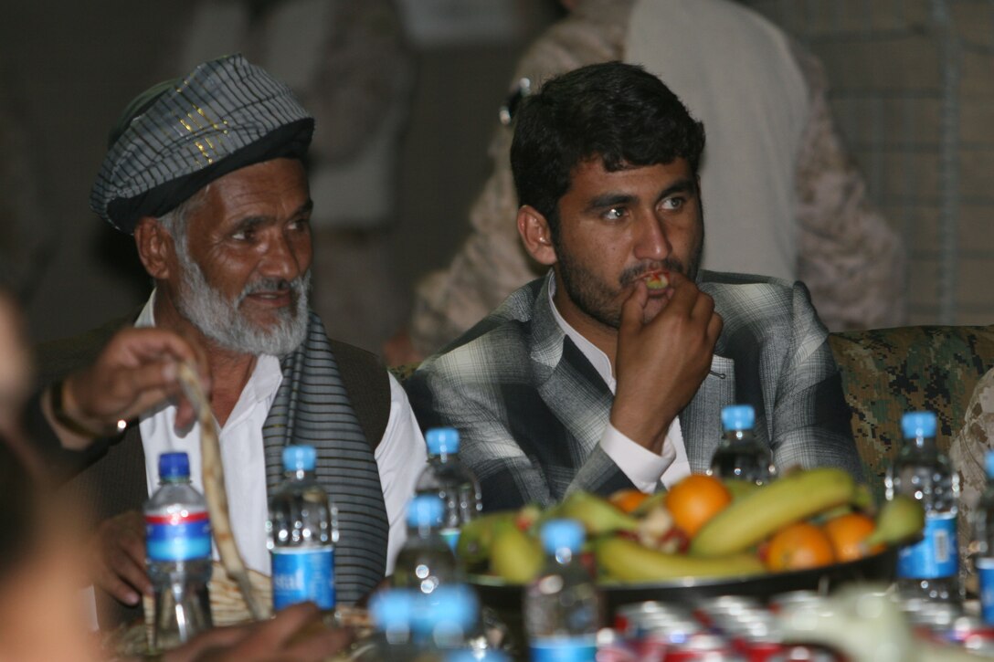 Mohammad Lal, left, the provincial governor’s chief of staff, and Mohammad Fahim, right, the district governor of Garmsir District, enjoy dinner on Forward Operating Base Delhi, Garmsir District, Helmand province, Afghanistan, May 1. The dinner was held as a time to begin to establish a strong relationship between 3rd Battalion, 1st Marine Regiment, and Afghan national security forces similar to the one that 2nd Battalion, 2nd Marine Regiment, and ANSF had.