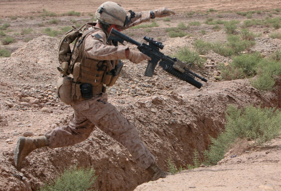 Lance Cpl. Keith Burggraff, a fireteam leader with Lima Company, 3rd Battalion, 6th Marine Regiment, leaps over an irrigation canal while on a patrol in Marjah, Helmand province, Afghanistan, May 1, 2010. Marines from 3/6 and soldiers from the Afghan National Army have been providing security and winning the support of locals in Marjah, an area accustomed to Taliban oppression in recent years.