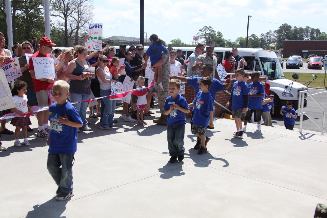 Parents welcome home their children after a simulated deployment during a Dependant Deployment Day, May 1. The youth spent the day learning about equipment and training, giving them insight on what their parents went through during deployment.