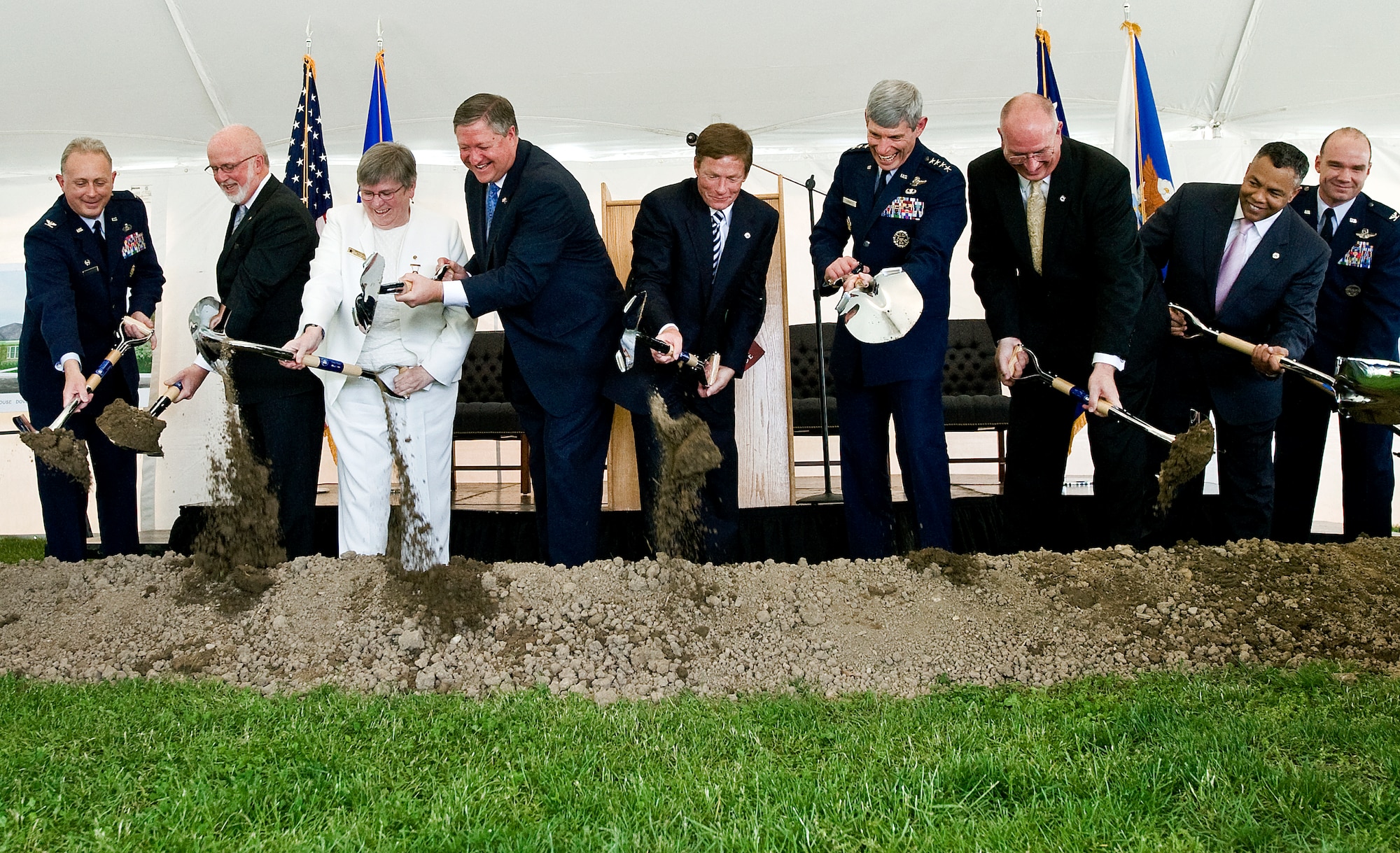 From left to right, Col. Robert H. Edmondson, commander of the Air Force Mortuary Affairs Operations Center, Gerry Byrne, Fisher House Foundation, Ruth Stonesifer, national president of the Gold Star Mothers of America, Michael B. Donley, secretary of the Air Force, Kenneth Fisher, Fisher House Foundation chairman, Gen. Norton A. Schwartz, Air Force chief of staff, David Coker, Fisher House Foundation president, Carl Zarrello, Fisher House Foundation, and Col. Manson Morris, commander of 436th Airlift Wing, turn shovels filled with soil in a groundbreaking ceremony May 1 for a new Fisher House at Dover Air Force Base, Del. This Fisher House is the first to be built and dedicated to provide hospice services to the families of fallen servicemembers. (U.S. Air Force photo/Staff Sgt. Bennie J. Davis III)