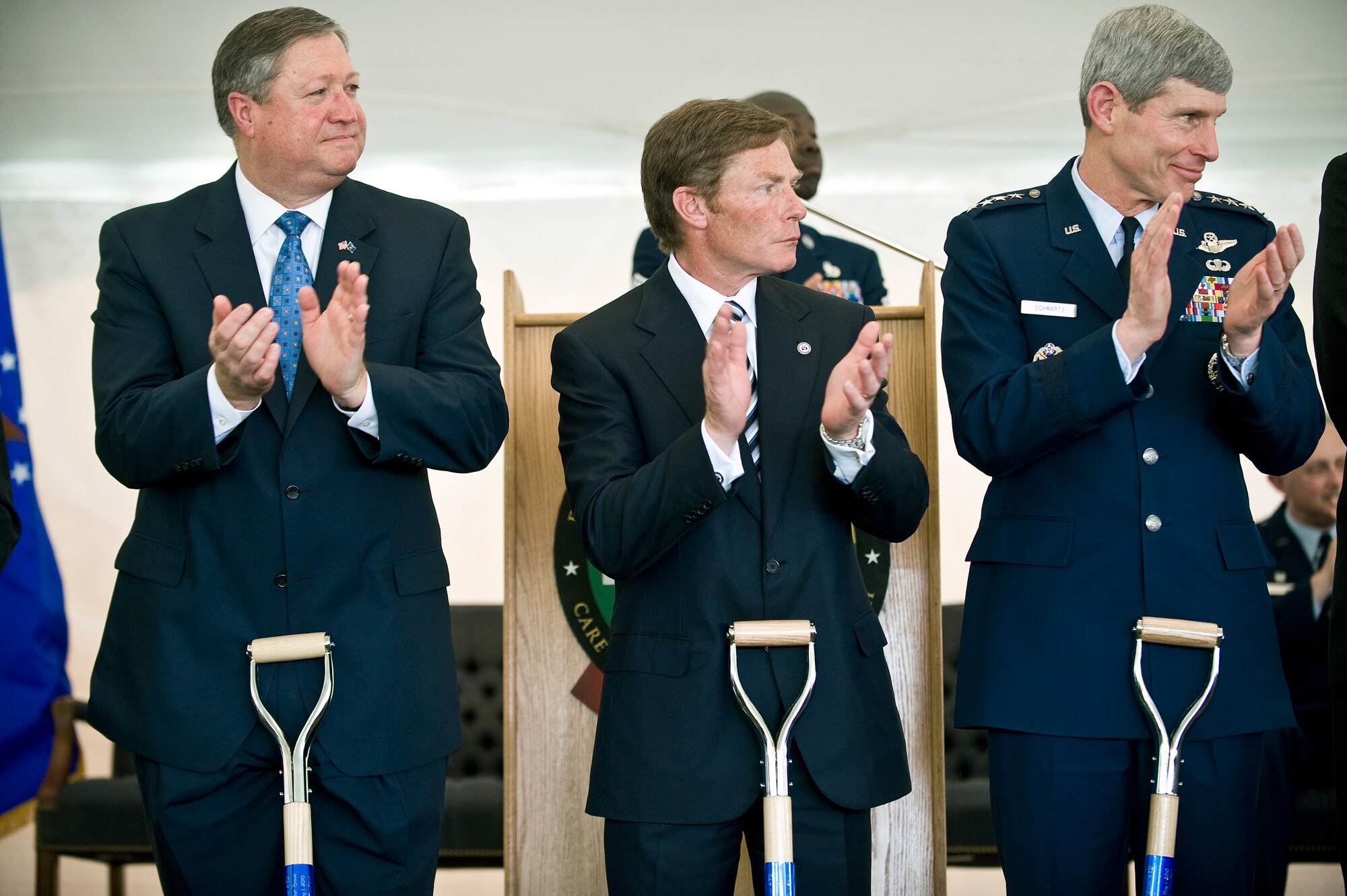 Michael B. Donley, secretary of the Air Force, (left) Kenneth Fisher, Fisher House Foundation chairman, and Gen. Norton A. Schwartz, Air Force chief of staff (right), applaud the official groundbreaking for the new Fisher House and meditation pavilion dedicated for the families of fallen heroes, May 1, at Dover Air Force Base, Del. (U.S. Air Force photo/Staff Sgt. Bennie J. Davis III)