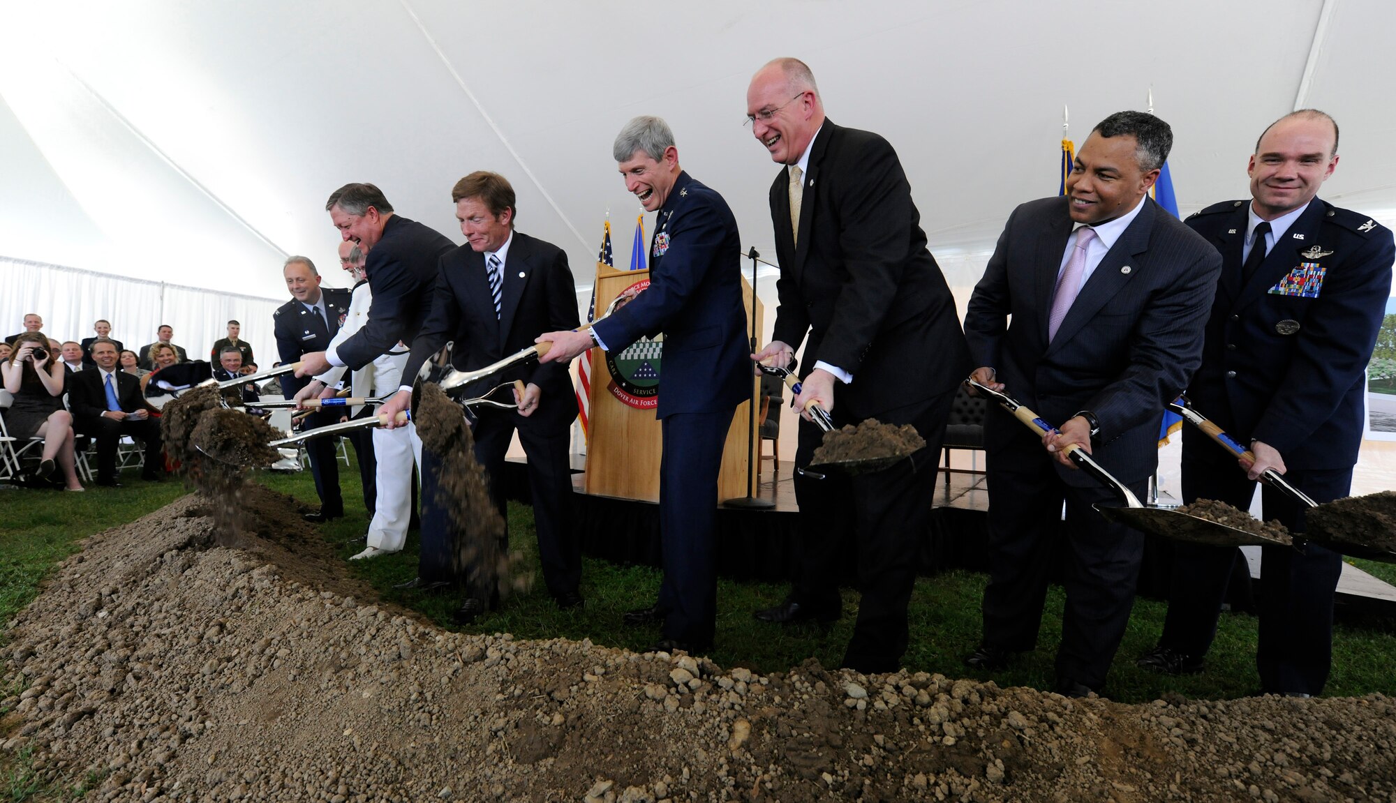 Secretary of the Air Force Michael B. Donley, center-left, Kenneth Fisher, chairman of the board of trustees for the Fisher House Foundation, Gen. Norton Schwartz, Air Force Chief of Staff, center, and others, turn shovels filled with soil in a groundbreaking ceremony for a new Fisher House at Dover Air Force Base, Del. This Fisher House is the first to be built and dedicated to provide hospice services to family members of fallen servicemembers. (U.S. Air Force photo/Scott M. Ash) 