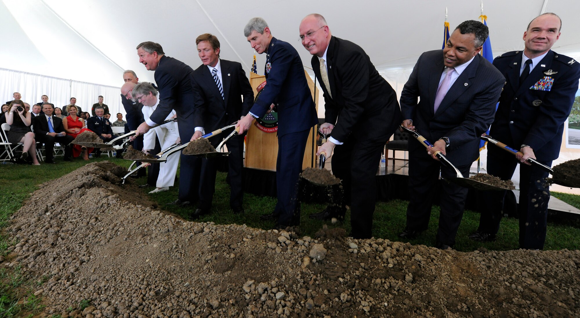 Secretary of the Air Force Michael B. Donley, center-left, Kenneth Fisher, chairman of the board of trustees for the Fisher House Foundation, Gen. Norton Schwartz, Air Force Chief of Staff, center, and others, turn shovels filled with soil in a groundbreaking ceremony for a new Fisher House at Dover Air Force Base, Del. This Fisher House is the first to be built and dedicated to provide hospice services to family members of fallen servicemembers.(U.S. Air Force photo/Scott M. Ash) 