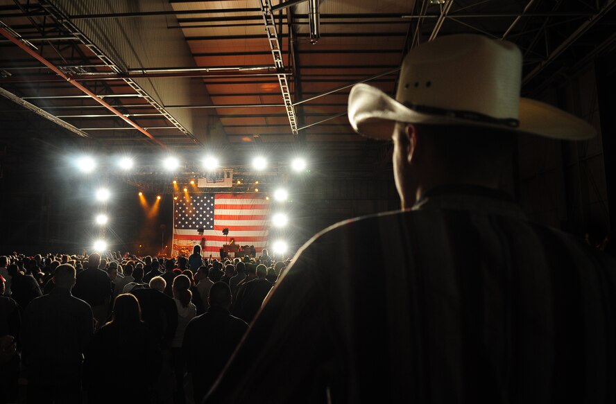 U.S. Air Force Airman 1st Class Jacob, Woodel, 786th Civil Engineer Squadron, waits for singer, songwriter and entertainer, Toby Keith to return to the stage for an encore during a free concert on Ramstein, Air Base, Germany, May 1, 2010. The Toby Keith concert, sponsored by the United Services Organization and Armed Forces Entertainment, was designed to entertain and help boost the morale of troops and their families.  Toby Keith will be making stops throughout Germany, Korea and the Persian Gulf during his 14-day country tour.  (U.S. Air Force photo by Staff Sgt. Jocelyn Rich)