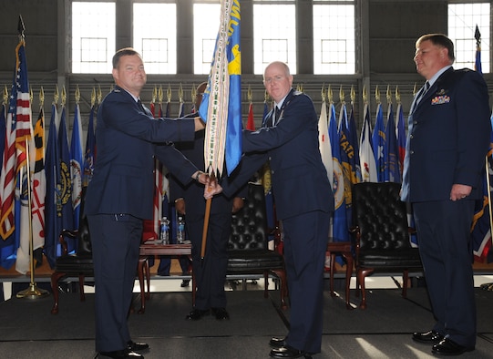 Col. David Pavey (left), the 927th Air Refueling Wing commander, passes the 927th Operations Group flag to new 927th OG commander, Col. Thomas Pemberton (center) at a change of command ceremony at MacDill Air Force Base, Fla., May 1, 2010, after former 927th OG commander, Col. Douglas Schwartz (right)relinquished command. The passing of the flag is an Air Force tradition symbolizing the transition of commanders. (U.S. Air Force photo by Senior Airman Anna-Marie Wyant)