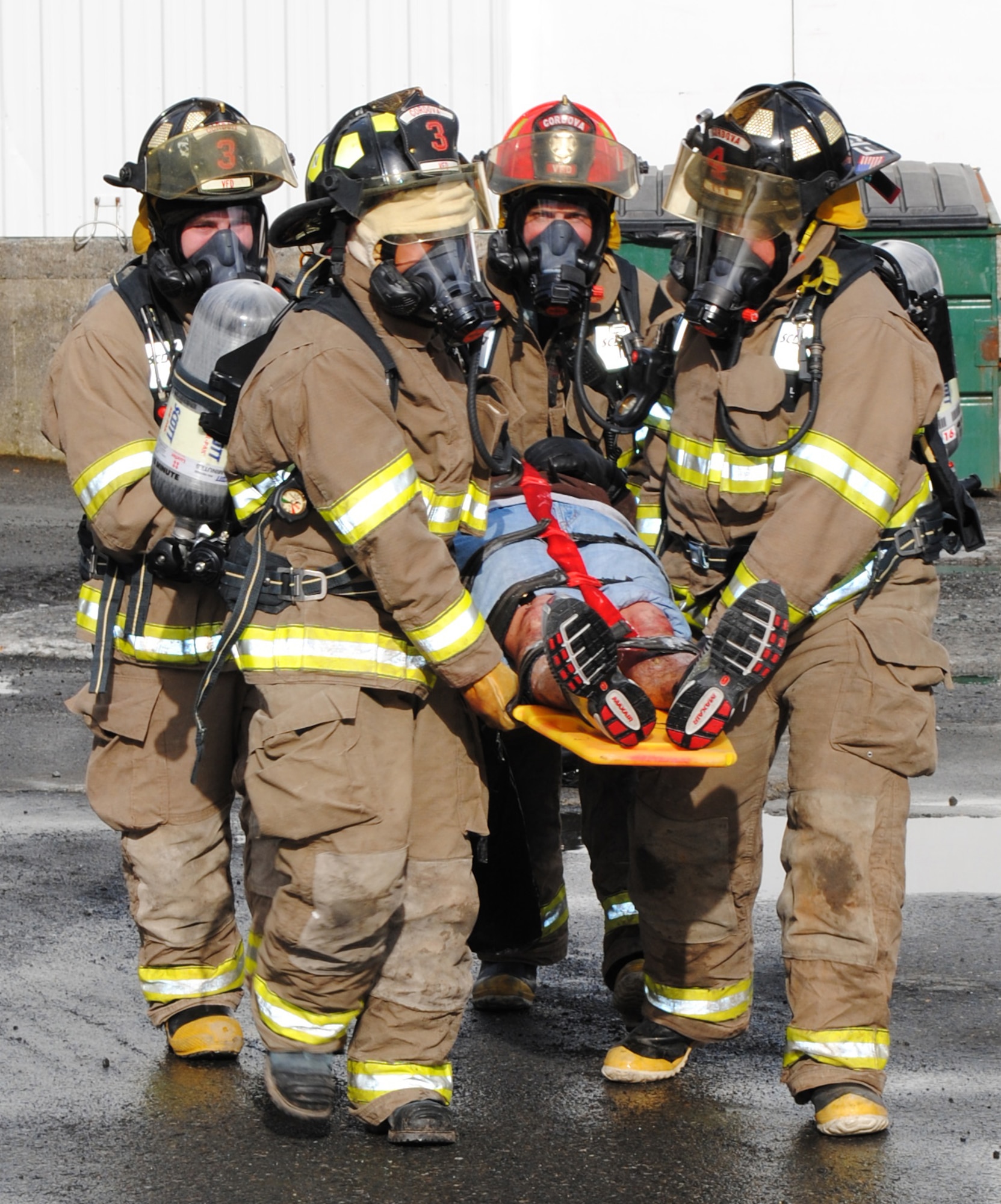 CORDOVA, Alaska -- A victim is carried away on a backboard by firefighters from the Cordova Volunteer Fire Department after a simulated earthquake and explosion occurred April 30, 2010, during Arctic Edge 10 training at the Trident Seafoods Alaskan plant in Cordova, Alaska.  This week-long exercise was conducted April 26 to May 1 and allowed emergency responders from federal, state and local agencies the opportunity to work together in a natural disaster scenario. (U.S. Army photo by Spc. Amie J. McMillan, 10th Press Camp Headquarters)