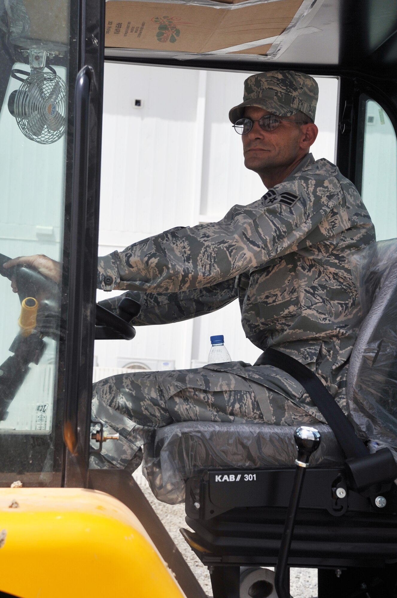 Senior Airman Larry S. Szyska, services journeyman with the 380th Expeditionary Force Support Squadron, uses a forklift to move a pallet of water during operations at a non-disclosed base in Southwest Asia on April 27, 2010. Airman Syska is deployed from the 127th Force Support Squadron at Selfridge Air National Guard Base, Mich., and his hometown is Harrison, Mich. (U.S. Air Force Photo/Master Sgt. Scott T. Sturkol/Released)