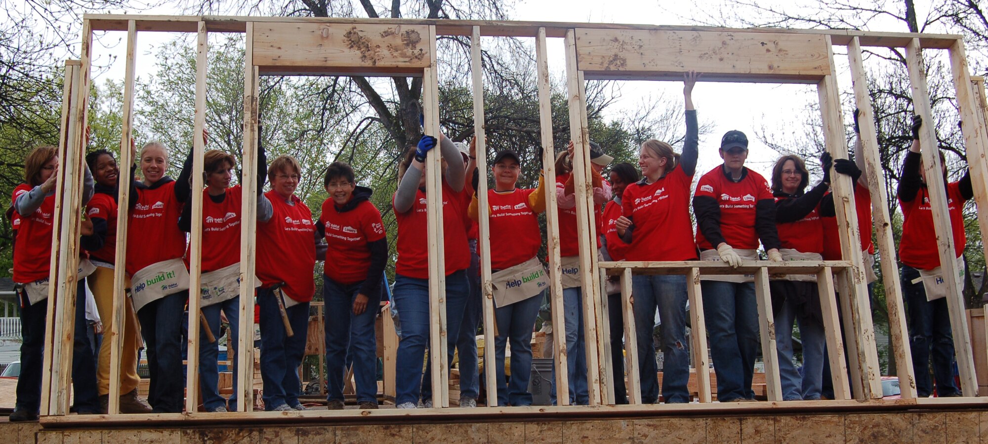 Airmen from Grand Forks Air Force Base, N.D. and local Grand cities volunteers raise the first wall to a new Red River Valley Habitat for Humanity build, May 1. The house is being built in Grand Forks, N.D. for single mother Anna Sepeda and her three children. (U.S. Air Force photo by 2nd Lt. Anastasia Wasem)