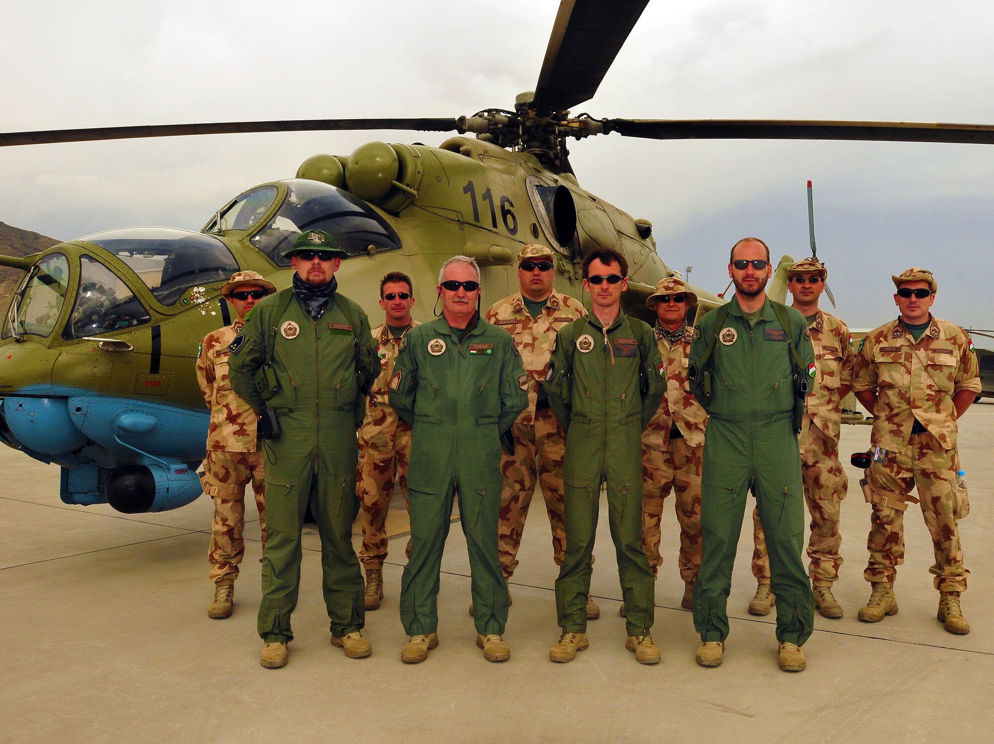 The 10 members of the new Hungarian training detachment of the Combined Air Power Transition Force, Stand before an Mi-35 attack helicopter on the Afghan National Army Air Corps base in Kabul, Afghanistan May 01, 2010. The Hungarians are deployed from the Home Defense Force, 86 Helicopter Regiment, Szolnok Helicopter Base and this is the first mission for the regiment outside of Hungary. (US Navy photo by Mass Communication Specialist 2nd Class David Quillen/ RELEASED)
