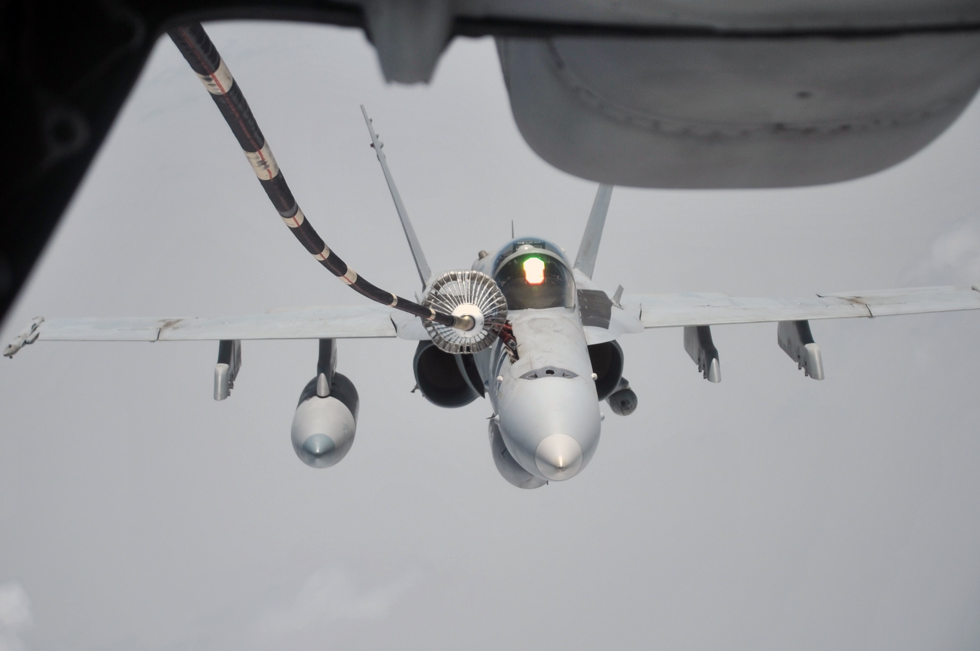 A U.S. Navy F-18 is shown flying in formation with a KC-10 Extender from the 908th Expeditionary Air Refueling Squadron during an air refueling mission in the U.S. Central Command area of responsibility on April 24, 2010. In the first three months of 2010, Airmen supporting the KC-10 deployed air refueling in the U.S. Central Command area of responsibility flew more than 1,000 sorties offl-loading more than 108 million pounds of fuel to more than 6,600 aircraft in support of combat operations. The 908th EARS, as part of the 380th Air Expeditionary Wing, supports operations Iraqi Freedom and Enduring Freedom and the Combined Joint Task Force-Horn of Africa. (U.S. Air Force Photo/Master Sgt. Scott T. Sturkol/Released)