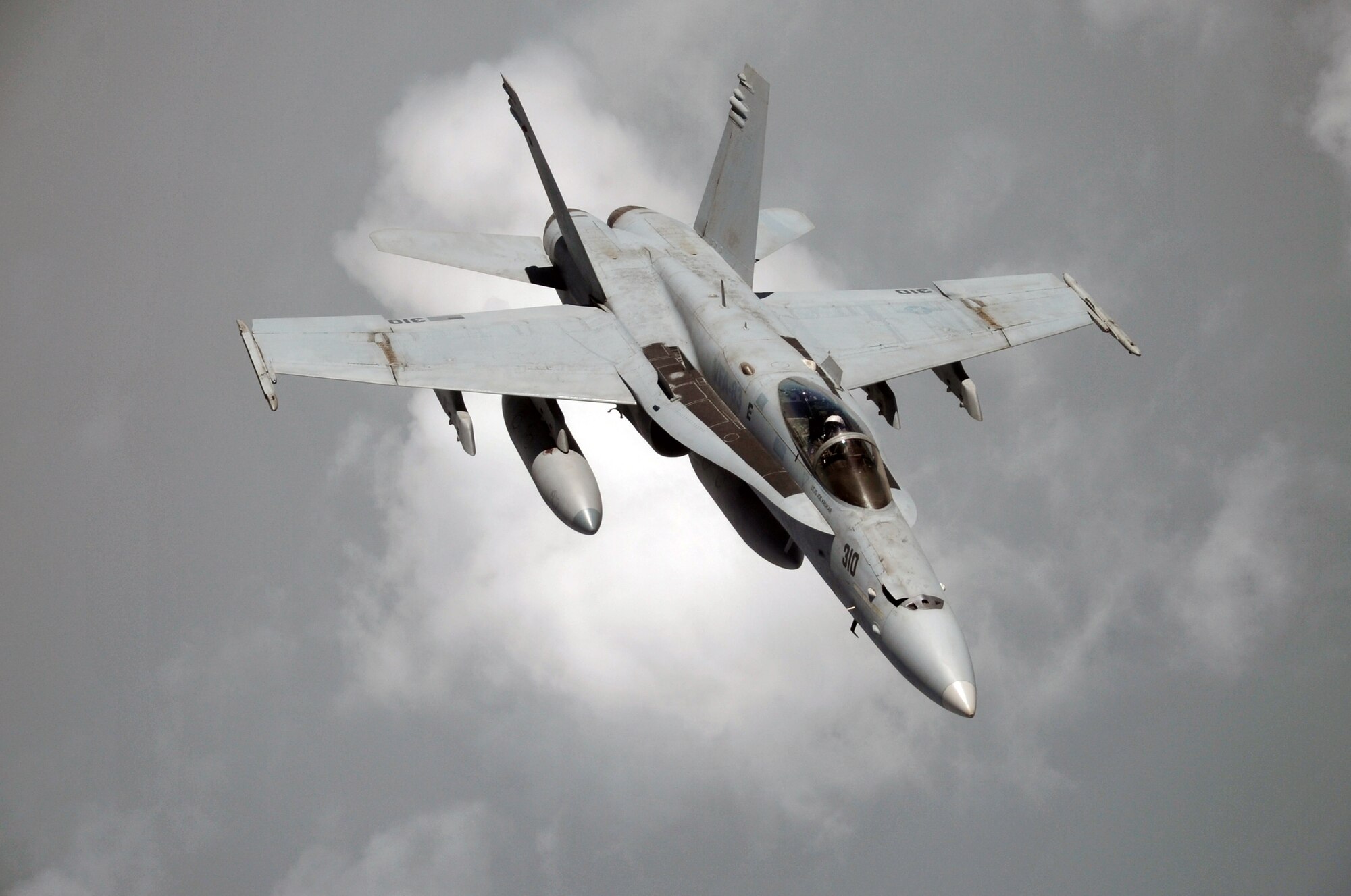 A U.S. Navy F-18 is shown flying in formation with a KC-10 Extender from the 908th Expeditionary Air Refueling Squadron during an air refueling mission in the U.S. Central Command area of responsibility on April 24, 2010. In the first three months of 2010, Airmen supporting the KC-10 deployed air refueling in the U.S. Central Command area of responsibility flew more than 1,000 sorties offl-loading more than 108 million pounds of fuel to more than 6,600 aircraft in support of combat operations. The 908th EARS, as part of the 380th Air Expeditionary Wing, supports operations Iraqi Freedom and Enduring Freedom and the Combined Joint Task Force-Horn of Africa. (U.S. Air Force Photo/Master Sgt. Scott T. Sturkol/Released)