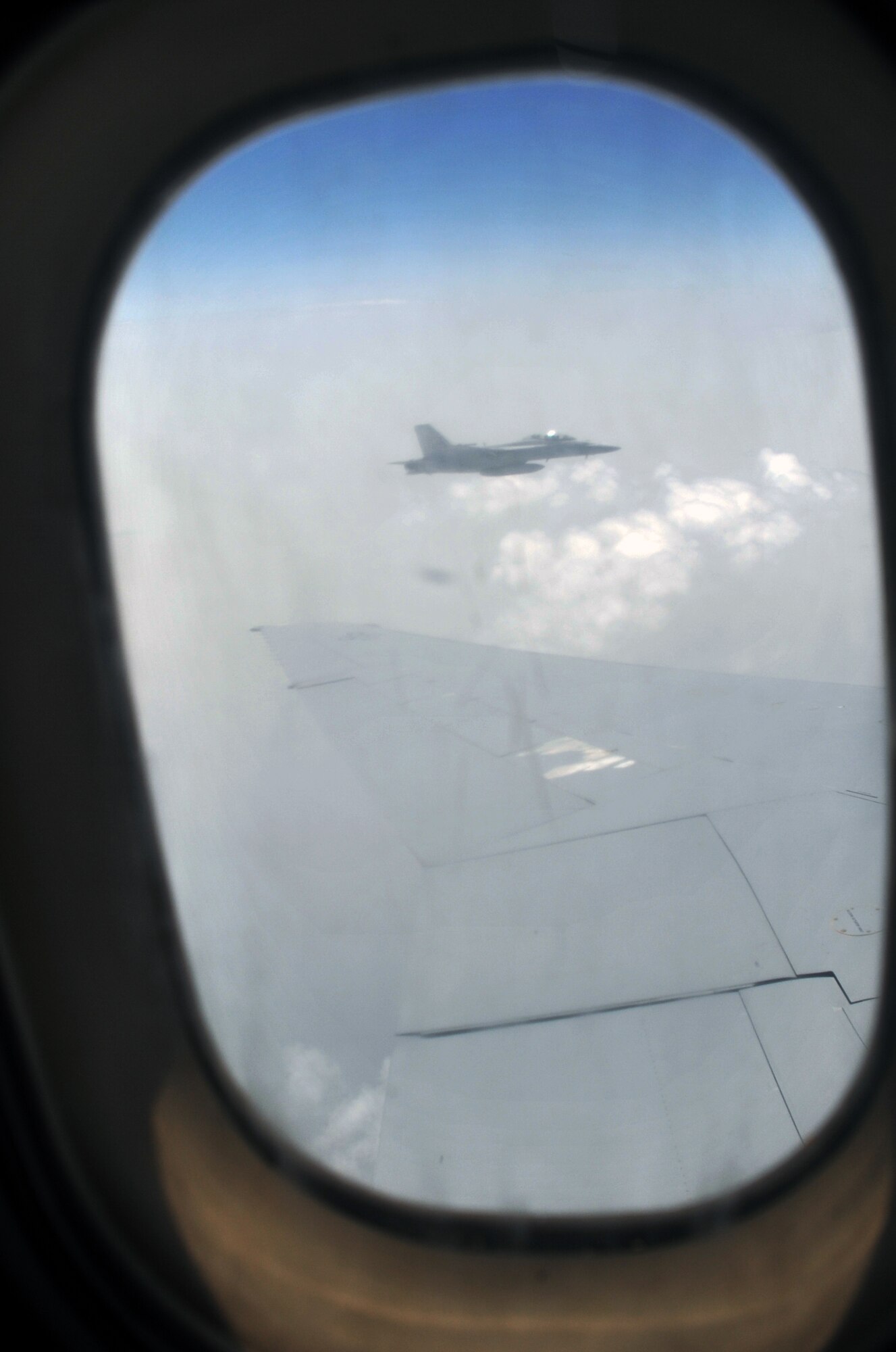 A U.S. Navy F-18 flies in formation with a KC-10 Extender from the 908th Expeditionary Air Refueling Squadron prior to it being refueled during an air refueling mission in the U.S. Central Command area of responsibility on April 24, 2010. In the first three months of 2010, Airmen supporting the KC-10 deployed air refueling in the U.S. Central Command area of responsibility flew more than 1,000 sorties offl-loading more than 108 million pounds of fuel to more than 6,600 aircraft in support of combat operations. The 908th EARS, as part of the 380th Air Expeditionary Wing, supports operations Iraqi Freedom and Enduring Freedom and the Combined Joint Task Force-Horn of Africa. (U.S. Air Force Photo/Master Sgt. Scott T. Sturkol/Released)