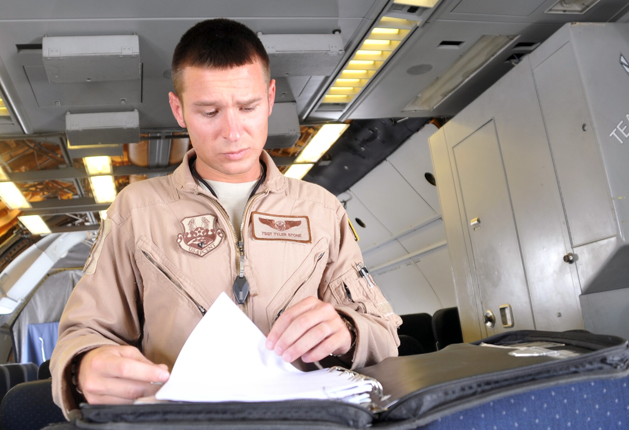 Tech. Sgt. Tyler Stone, KC-10 Extender boom operator with the 908th Expeditionary Air Refueling Squadron, goes over his checklist while preparing for a mission from a non-disclosed base on Southwest Asia on April 24, 2010. Sergeant Stone is deployed from the 2nd Air Refueling Squadron at Joint Base McGuire-Dix-Lakehurst, N.J., and his hometown is Red Hill, Penn. (U.S. Air Force Photo/Master Sgt. Scott T. Sturkol/Released)