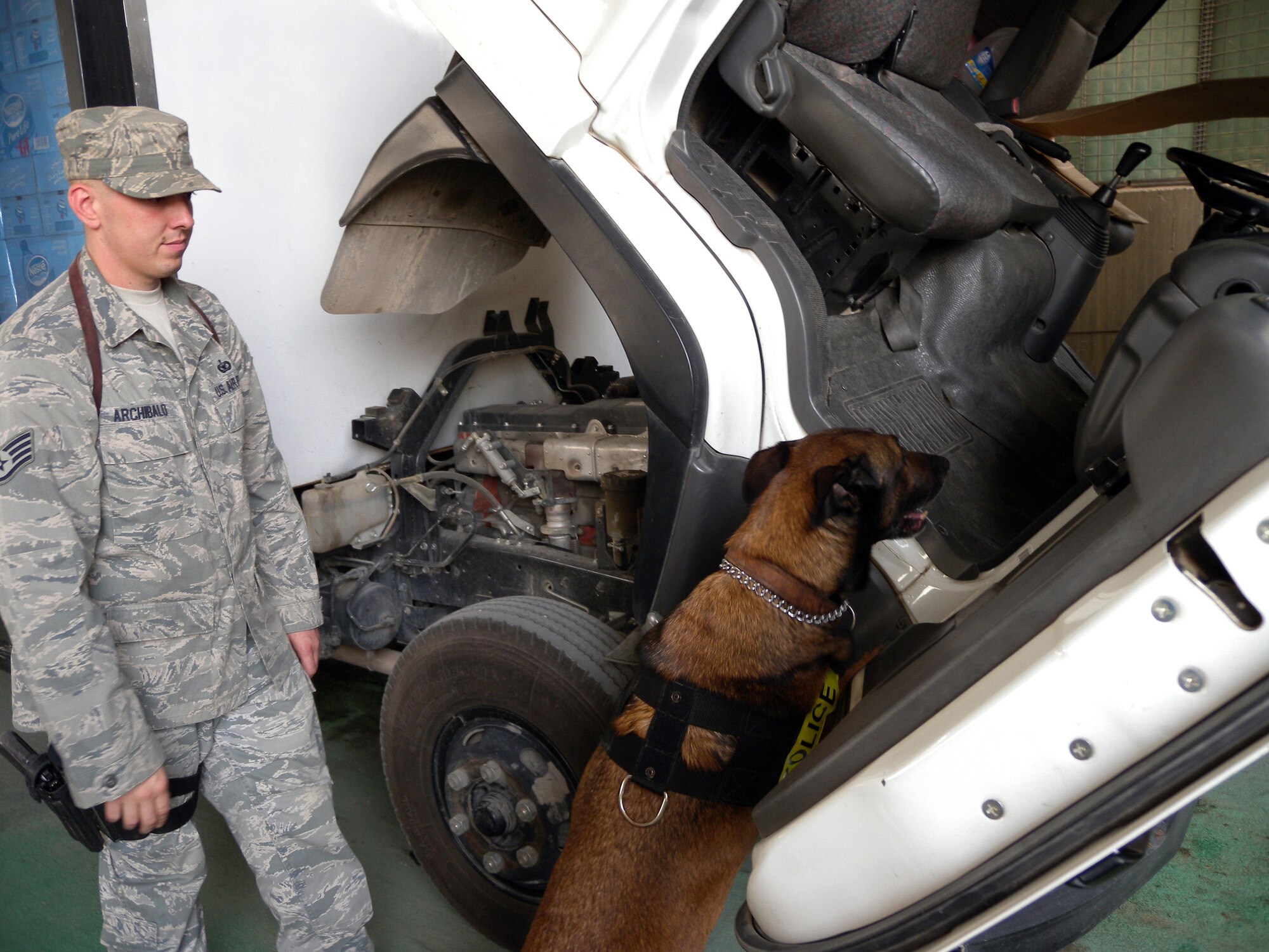 Staff Sgt. Joshua Archibald, 64th Security Forces Squadron member, and Military Working Dog Diego perform a vehicle search at a non-disclosed Southwest Asia location April 22, 2010. [RELEASED]