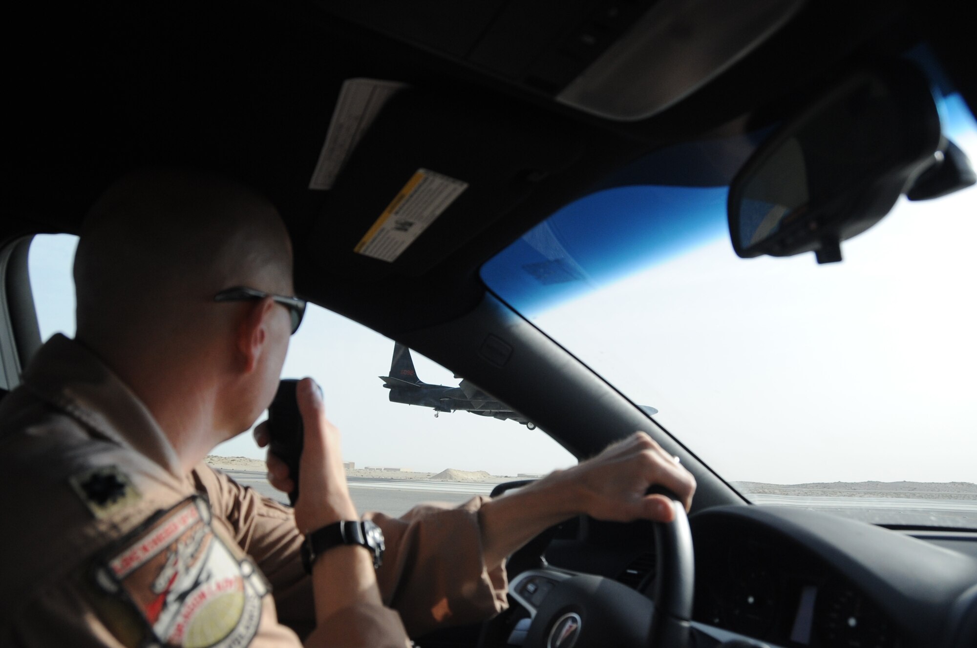 Lt. Col. Kirt Stallings, 99th Expeditionary Reconnaissance Squadron commander, drives the chase car, which gives visual assistance to U-2 Dragon Lady pilots,  as Col. Soren Jones, 380th Expeditionary Operations Group commander, lands a  U-2 Dragon Lady an undisclosed location in Southwest Asia on April 30, 2010. The 380th Air Expeditionary Wing, supports Operations Iraqi Freedom and Enduring Freedom and the Combined Joint Task Force-Horn of Africa. The 380th AEW is comprised of four groups and 12 squadrons and the wing's deployed mission includes air refueling, surveillance and reconnaissance in support of overseas contingency operations in Southwest Asia. (U.S. Air Force photo/Senior Airman Jenifer H. Calhoun/Released)
