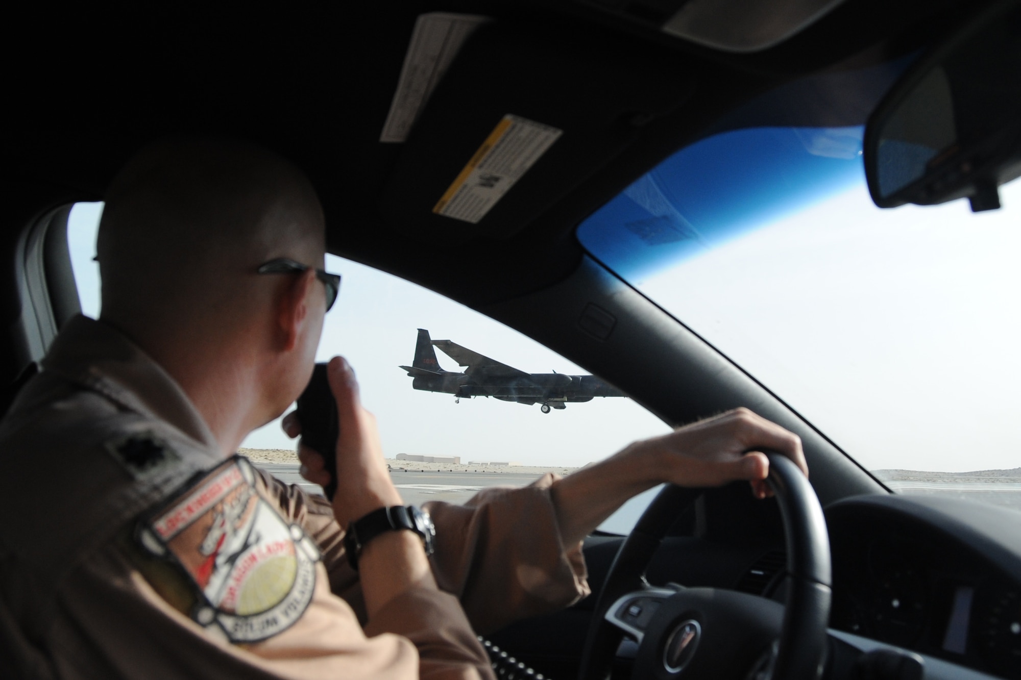 Lt. Col. Kirt Stallings, 99th Expeditionary Reconnaissance Squadron commander, drives the chase car, which gives visual assistance to U-2 Dragon Lady pilots,  as Col. Soren Jones, 380th Expeditionary Operations Group commander, lands a  U-2 Dragon Lady an undisclosed location in Southwest Asia on April 30, 2010. The 380th Air Expeditionary Wing, supports Operations Iraqi Freedom and Enduring Freedom and the Combined Joint Task Force-Horn of Africa. The 380th AEW is comprised of four groups and 12 squadrons and the wing's deployed mission includes air refueling, surveillance and reconnaissance in support of overseas contingency operations in Southwest Asia. (U.S. Air Force photo/Senior Airman Jenifer H. Calhoun/Released)
