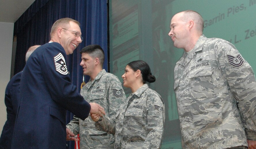 Chief Master Sgt. Joe Westerlund shakes the hand of recent quarterly award winners May 2 during the spring 2010 commanders call at Peterson Air Force Base, Colo. During the commander's call, Col. Bob Chapman, 302nd Airlift Wing vice commander, also recognized several other individuals and agencies for their achievements. Later, the colonel addressed upcoming events within the 302nd AW as well as a recent spike in accidental deaths in the Air Force. Chief Westerlund is the 302nd AW's command chief. (U.S. Air Force photo/Tech. Sgt. Daniel Butterfield)