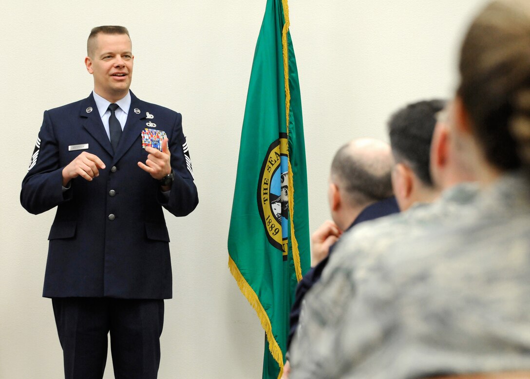Chief Master Sgt. Neil Andersen wears his new stripes for the first time as he speaks to fellow members of the 141st Air Refueling Wing during his promotion ceremony. CMSgt Andersen has been a member of the 141st ARW since 1994 and is currently the Communications Operations Branch Chief for the 141st Communications Flight. (U.S. Air Force photo by Staff Sgt. Anthony Ennamorato/Released)