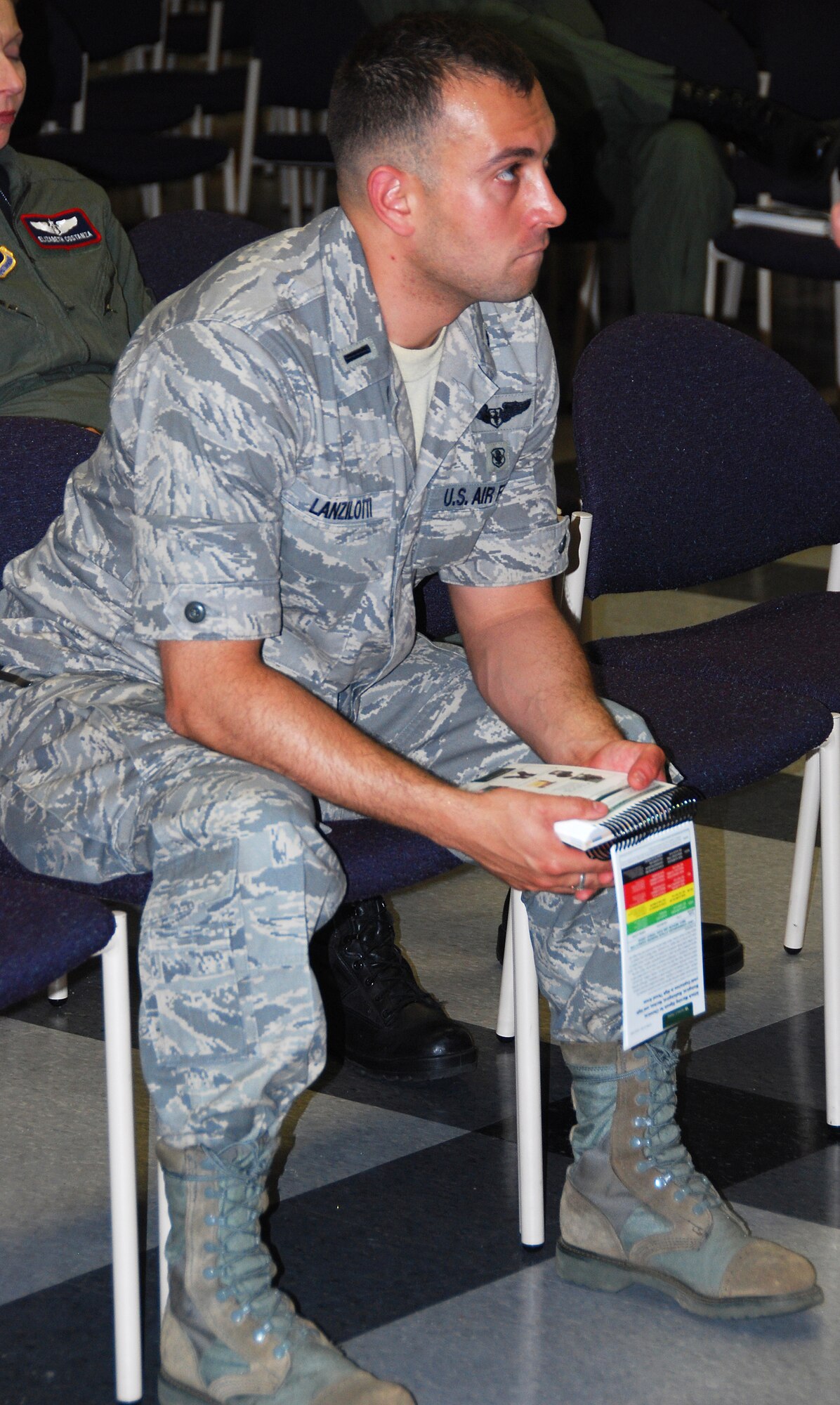 JOINT BASE MCGUIRE-DIX-LAKEHURST, N.J. ? Second Lieutenant John Lanzilotti, 514th Aeromedical Evacuation Squadron, listens to a training lesson on the proper wear and function of chemical protective gear here May 2, 2010. Lieutenant Lanzilottti holds an Airman?s Manual, a quick-action reference handbook for general deployment tactics, techniques and procedures. (U.S. Air Force photo/Staff Sgt. Shawn J. Jones)