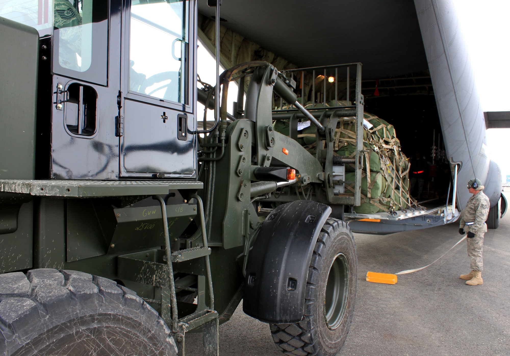 KOTZEBUE, Alaska -Aerial porters from various units, including the 86th Aerial Port Squadron, Joint Base Lewis-McChord, Wash., load medical and general supplies aboard the C-17 Globemaster III aircraft, to be delivered to Alaskan locals in remote villages. The 446th Airlift Wing, Joint Base Lewis-McChord, took part of Operation Arctic Care, a joint-service medical readiness and logistics training exercise that provided humanitarian assistance to underserved communities in the U.S. The three-week operation ended April 26. (U.S. Air Force Photo)