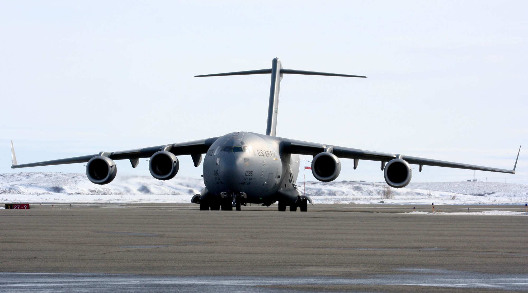 KOTZEBUE, Alaska - A C-17 Globemaster III aircraft parks in front an icy backdrop, ready for its next flight. Aerial porters from the 86th Aerial Port Squadron, Joint Base Lewis-McChord, helped move more than 280 military members, medical professionals, and vital medical supplies to Alaskan locals in remote villages. The Reservists were part of Operation Arctic Care, a joint-service medical readiness and logistics training exercise that provides humanitarian assistance to underserved communities in the U.S. (U.S. Air Force Photo)