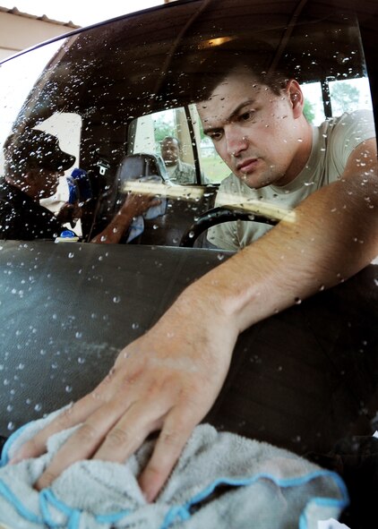 Amn. Christof Bader, 919th Aircraft Maintenance Squadron, wipes down the interior of a bobtail truck May 1 at Duke Field.  Members of the squadron brought over regularly used vehicles to the wash rack for a much-needed cleaning.  (U.S. Air Force photo/Tech. Sgt. Samuel King Jr.)