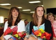 Dianne McKaye and Kilee McHenry, wife and stepdaughter of Lt. Col. John McKaye, listen to his speech after he took command of the 919th Operations Support Squadron May 1 at Duke Field.  Colonel McKaye took the reins from Lt. Col. Alex Sewell.  (U.S. Air Force photo/Tech. Sgt. Cheryl Foster)