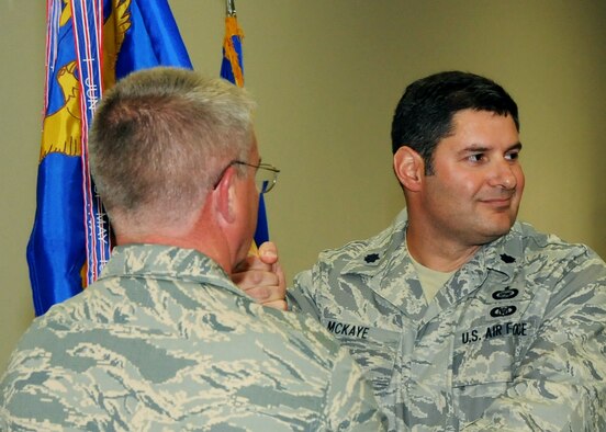 Lt. Col. John McKaye accepts the 919th Operations Support Squadron guidon  and command from Col. Donald Buckley, 919th Operations Group, during the squadron's change of command ceremony May 1 at Duke Field.  Colonel McKaye took the reins from Lt. Col. Alex Sewell.  (U.S. Air Force photo/Tech. Sgt. Cheryl Foster)