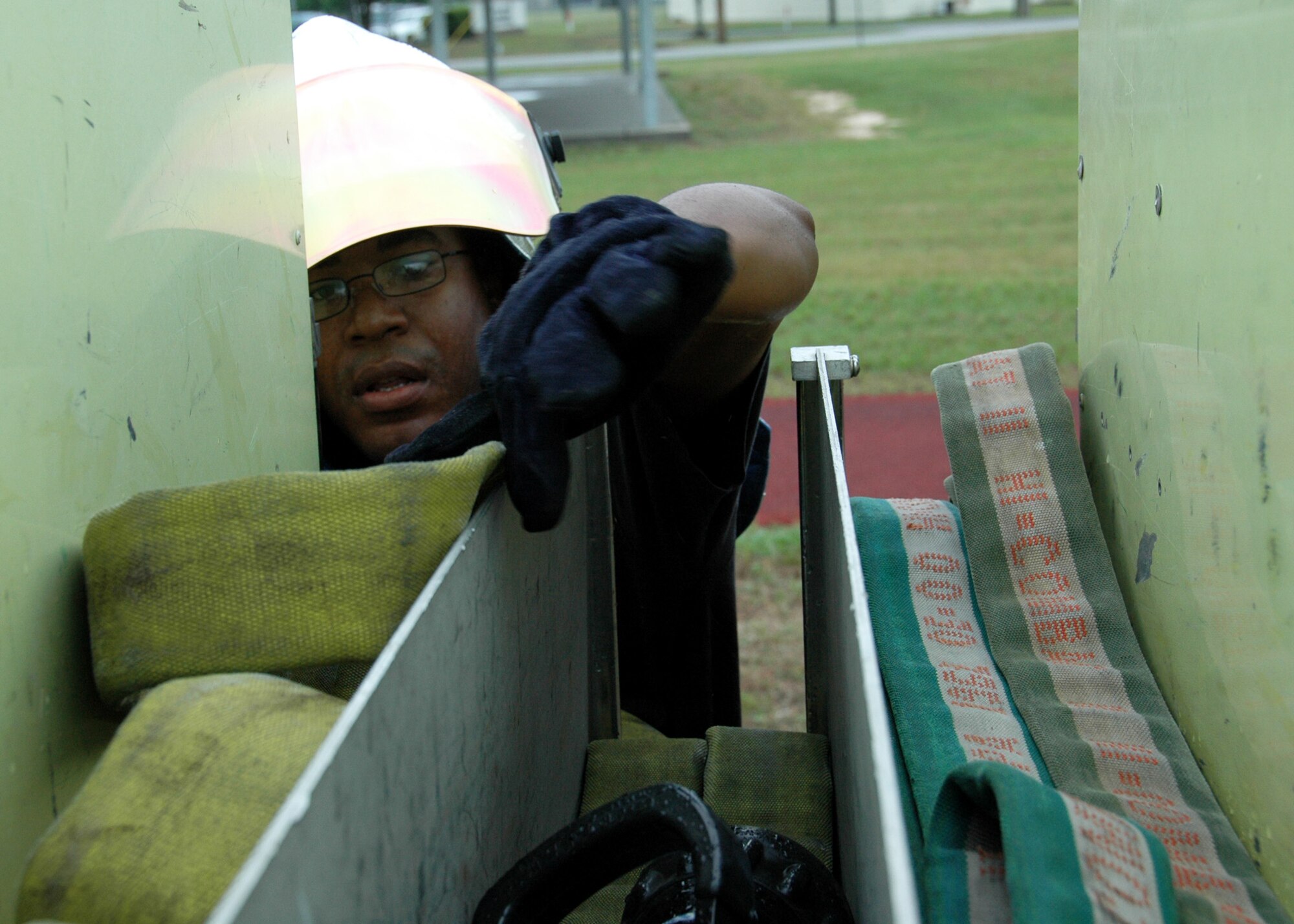 Senior Airman Ronald Haynes, 919th Civil Engineer Squadron, grabs another water hose from the fire truck during the hazardous material exercise May 1 at Duke Field.  Two NCOs were being graded on their command and control abilities for their DoD firefighter certification.  (U.S. Air Force photo/Tech. Sgt. Cheryl Foster)