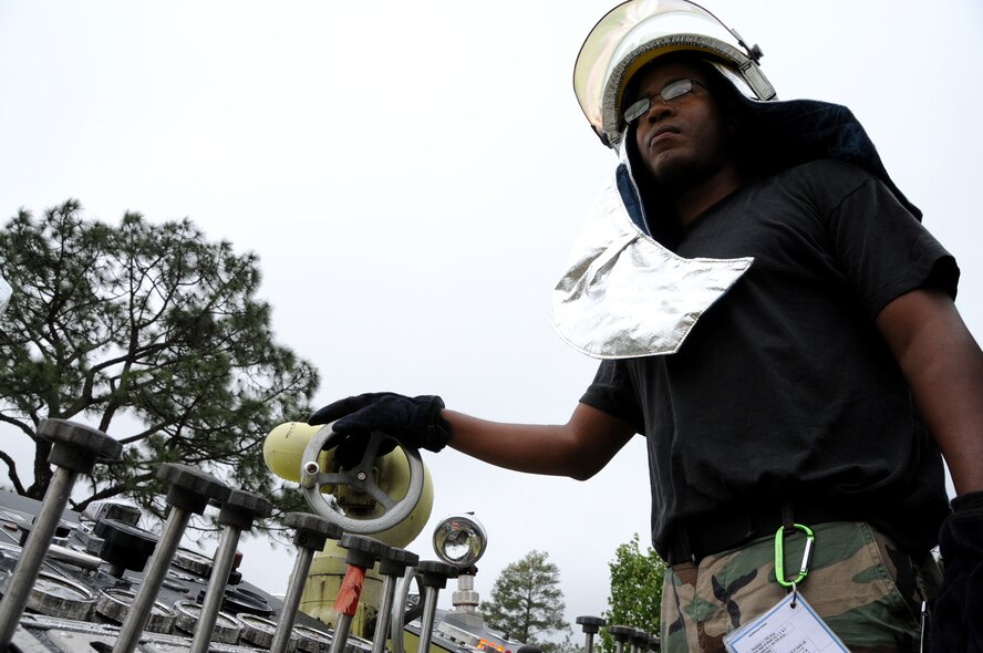 Senior Airman Ronald Haynes, 919th Civil Engineer Squadron, manages the water supply on the fire truck  during the hazardous material exercise May 1 at Duke Field.  Two NCOs were being graded on their command and control abilities for their DoD firefighter certification.    (U.S. Air Force photo/Tech. Sgt. Samuel King Jr.) 