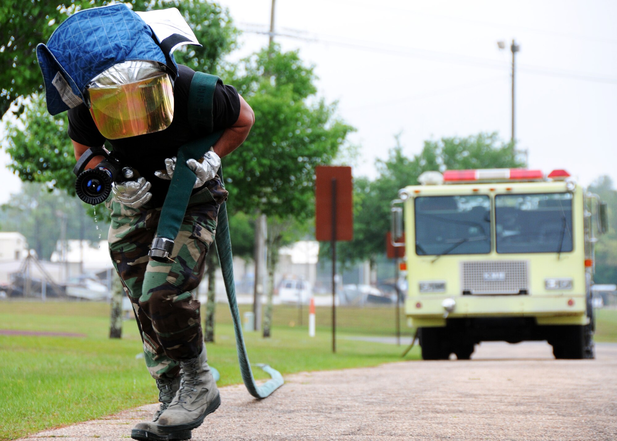 Airman 1st Class Alexander Carnathan, 919th Civil Engineer Squadron, drags a fire hose into place prior to the hazardous material exercise May 1 at Duke Field.  Two NCOs were being graded on their command and control abilities for their DoD firefighter certification.    (U.S. Air Force photo/Tech. Sgt. Samuel King Jr.)
