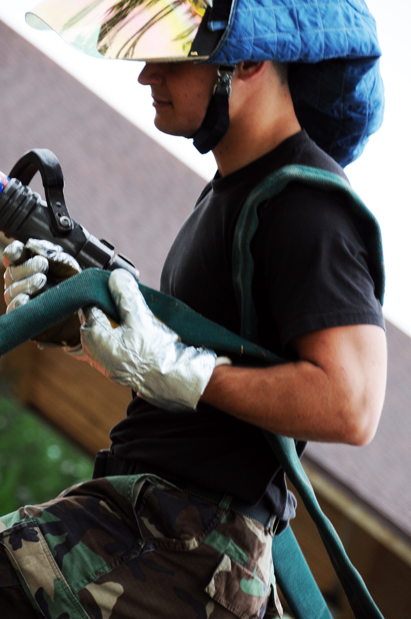 Airman 1st Class Alexander Carnathan, 919th Civil Engineer Squadron, drags a fire hose into place prior to the hazardous material exercise May 1 at Duke Field.  Two NCOs were being graded on their command and control abilities for their DoD firefighter certification.  (U.S. Air Force photo/Tech. Sgt. Samuel King Jr.)
