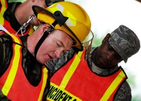 Tech. Sgt.s Shannon Daniels and David Davis, 919th Civil Engineer Squadron, talk over the plan of a hazardous material exercise May 1 at Duke Field.  The two NCOs were being graded on their command and control abilities for their DoD firefighter certification.  (U.S. Air Force photo/Tech. Sgt. Samuel King Jr.)