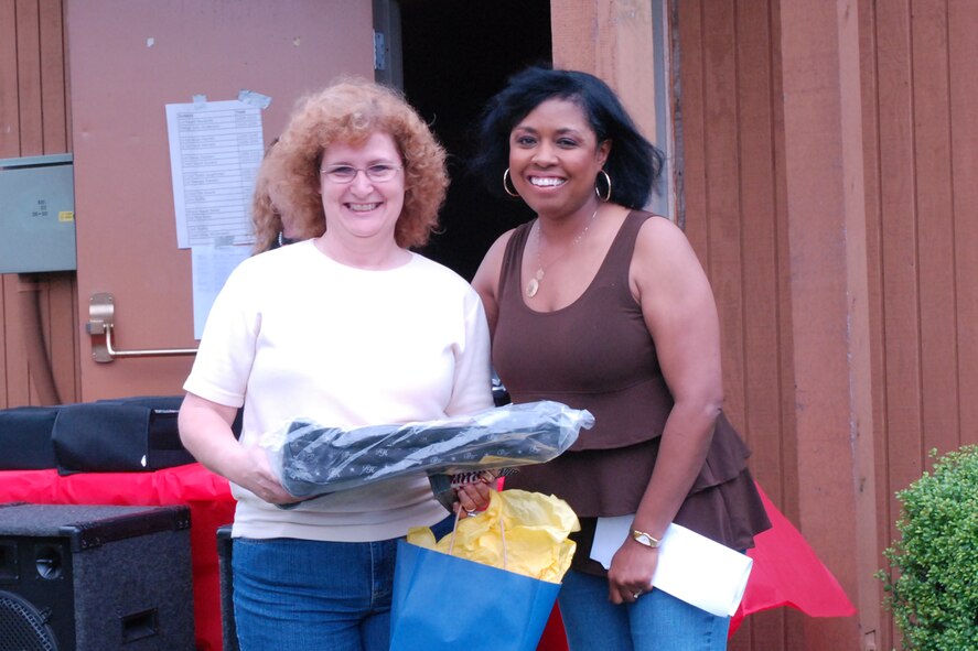 Angela Pedersen, director, 94th Family Support, presents spouse of the year award to Lorraine LaRue at the Family Day event here May 1. Family day is an opportunity for families to show their thanks and support to reserve members. (US Air Force photo/Staff Sgt. Samuel Hunt)