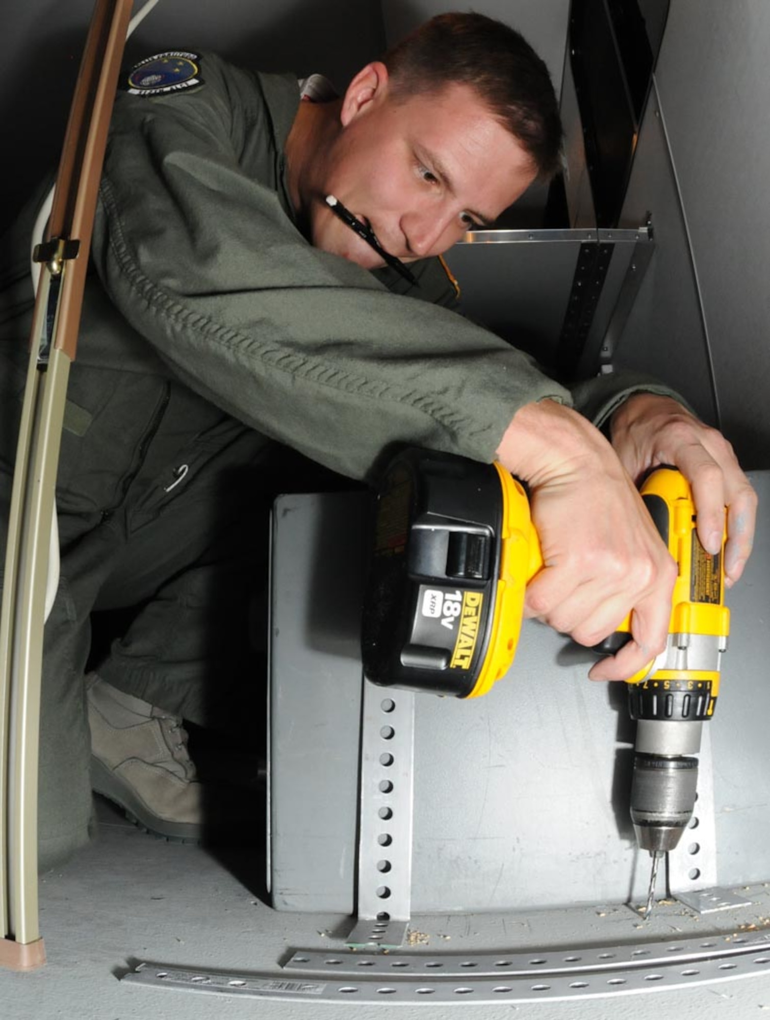 Master Sgt. Sean Pyne, 512th Airlift Control Flight loadmaster, drills holes to mount a safe to a trailer floor in the 512th ALCF hangar bay here April 23. To accommodate technology, the 512th ALCF received three new trailers in January as part of an Air Force Reserve Command modernization effort. Functioning as small command and control packages, the trailers are intended for 12-hour operations in austere locations. One of the remodeling changes is space optimization. The new units will have affixed radios and a mounted radio mast. Also, the new trailers boast more power with two new electrical boxes and larger generator.  The previously used models will be given to other units throughout the Reserve. This project is expected to continue until July, 2010. (U.S. Air Force photo/Staff Sgt. James Bolinger)