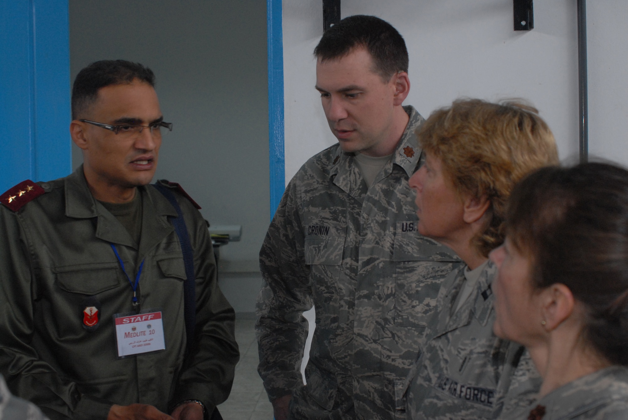 Air Force Maj. Peter Cronin, Capt. Janice Weixelman, and Maj. Debra Walker, medical providers with the 153rd Medical Group, 153rd Airlift Wing, Wyoming Air National Guard speak with Tunisian Army Captain Aref Zribi during the MEDLITE-10 exercise at Kharrouba Air Base, Bizerte, Tunisia. United States service members from Wyoming, Arizona, Nevada, and Illinois are in Tunisia as part of the U.S. partnership program with the North African nation exchanging medical treatment practices and programs. (USAF Photo by Master Sgt. Paul Mann/Released)
  