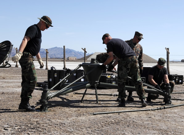 Members of the 109th Air Control Squadron prepare for Operation Big Crow in Wendover, Utah on April 24.  Master Sgt. David Weber, Master Sgt. Brian Carter, Staff Sgt. Jeremy Whisman, and Staff Sgt. Jared Rich are working on the assembly of the TSC-179 satellite antenna in support of the operation.  (U.S. Air Force photo by Technical Sgt. Kelly Collett)	