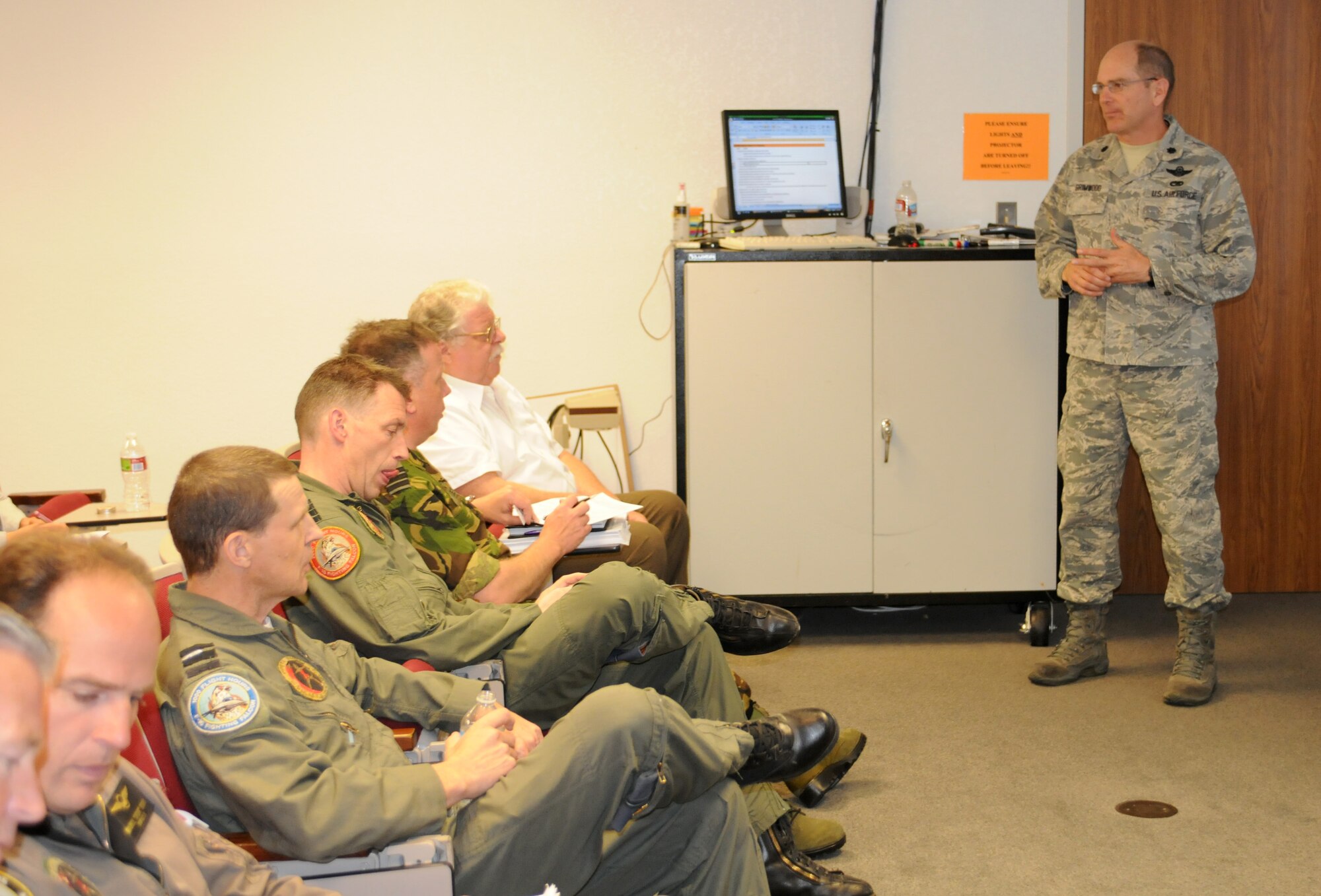Lt. Col. Dan Grimwood, 162nd Aircraft Maintenance Squadron commander, briefs a team of Dutch airmen and Arizona Air Guardsmen on maintenance and logistics issues associated with bringing Royal Netherlands Air Force F-16 pilot training back to Tucson International Airport, April 27. (Air Force photo by Maj. Gabe Johnson)