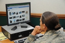 Master Sgt. Wendy Lopedote, of the 916th Public Affairs Office, checks her Facebook account during the May unit training assembly weekend. (USAF photo by TSgt. Scotty Sweatt, 916ARW/PA).
